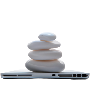 Shiny white pebbles stacked on a closed laptop